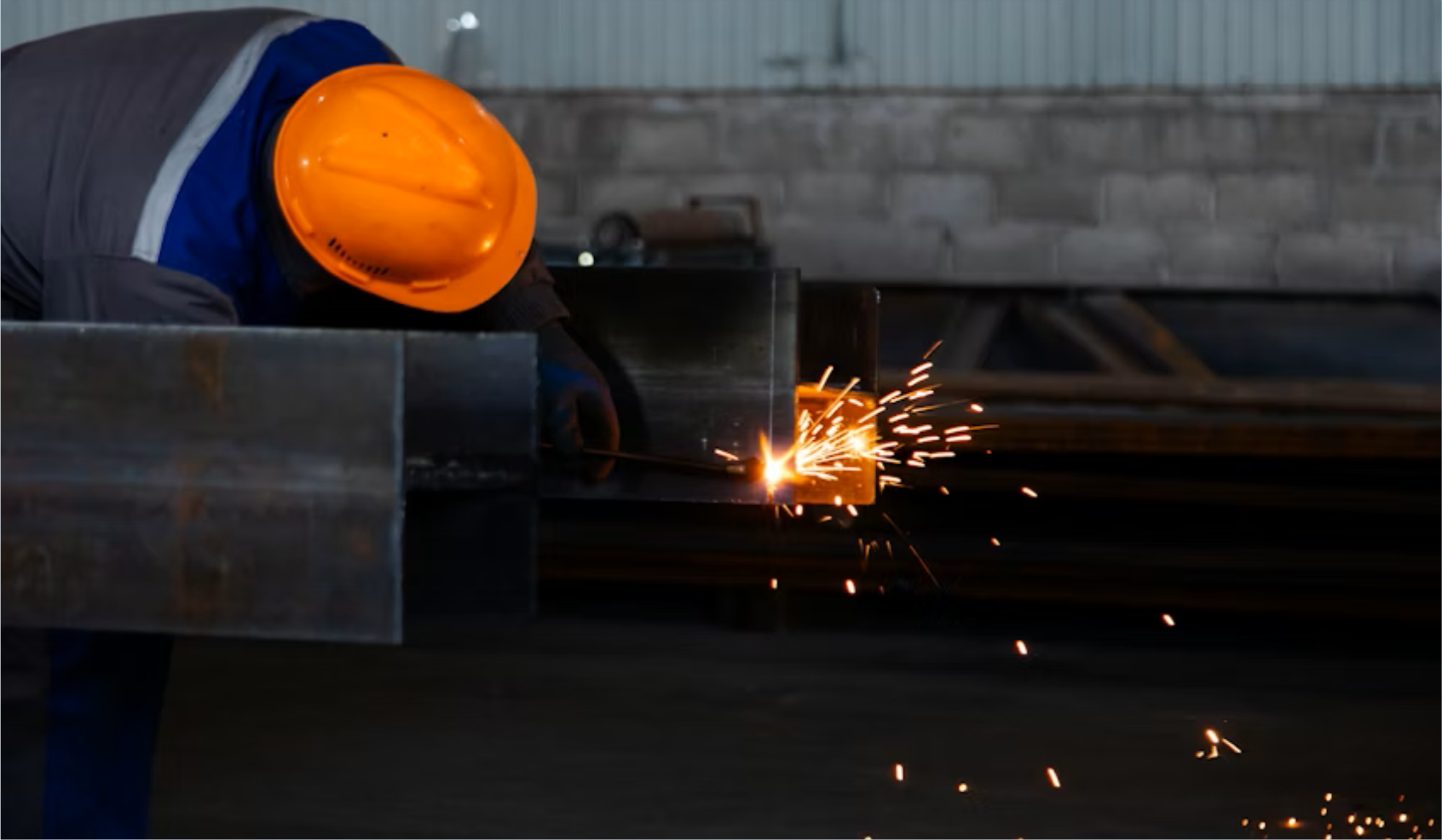 A worker welding metals together