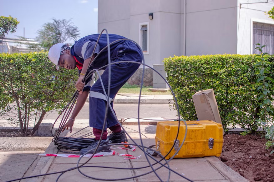 A skilled worker rolling a long wire